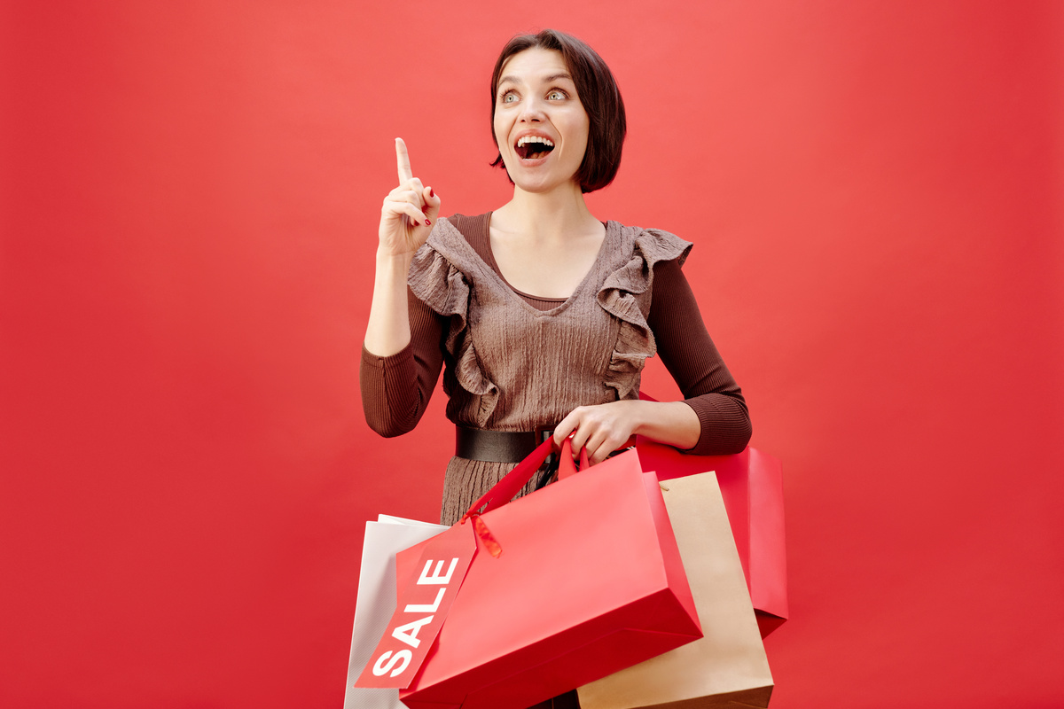 Woman Wearing a Brown Dress Carrying Shopping Bags